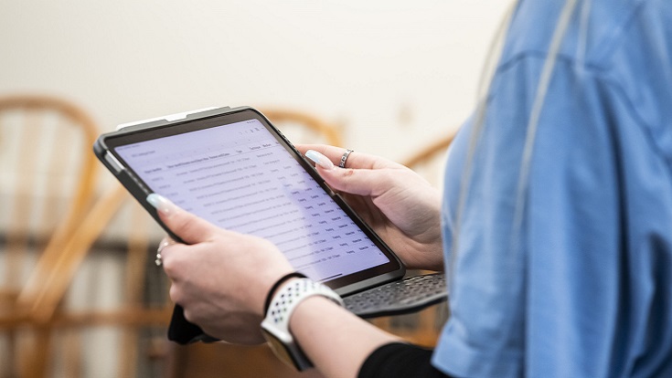 Photograph of person holding a tablet PC