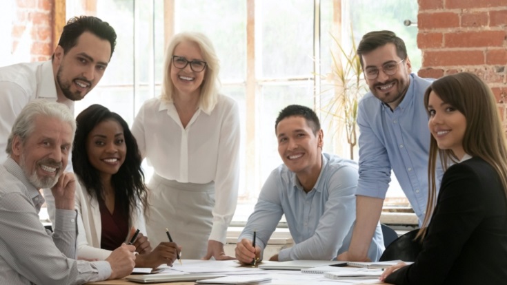 Photograph of people at a desk