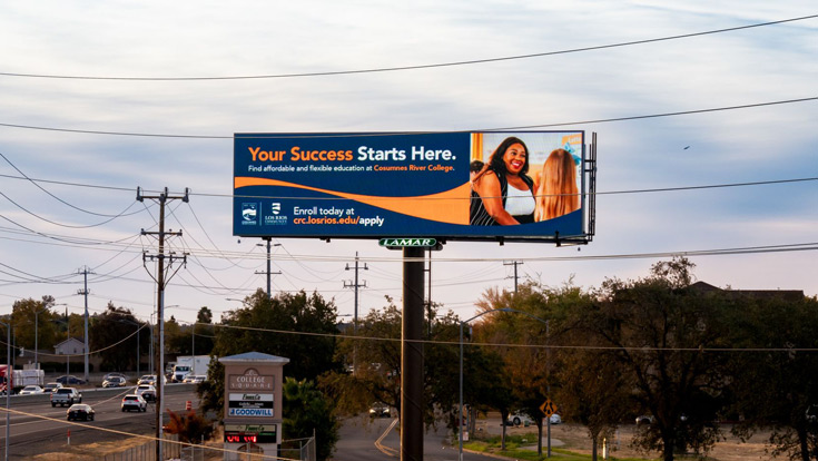 Billboard for Cosumnes River College against a backdrop of trees