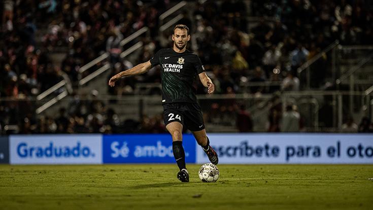 Los Rios advertising banner in the background of a Sac Republic FC soccer player